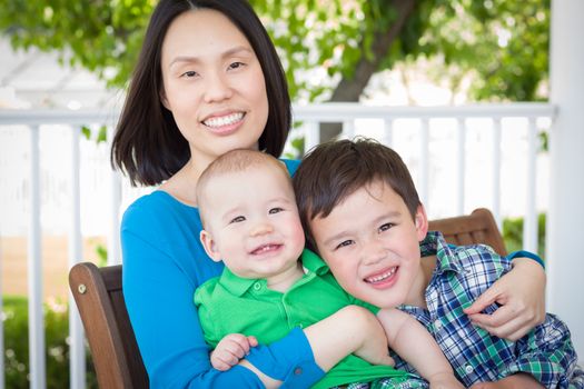 Outdoor Portrait of A Chinese Mother with Her Two Mixed Race Chinese and Caucasian Young Boys
