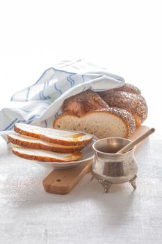 Braided Challah bread and honey on the table