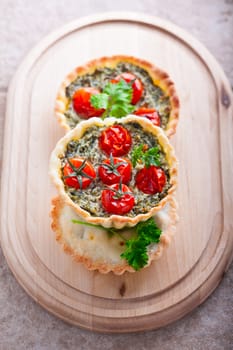 Mini Spinach Quiche served on a wooden plate