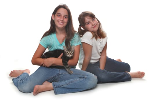 Sisters Holding Their Young Kitten on White
