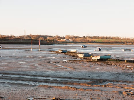 A wonderful shot of the river and its bank with the tide out on a clear day with boats