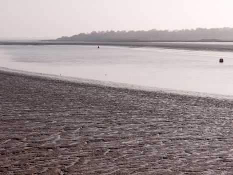 Various shots of the river and the mud, along with many birds, buoys, and other sea structures, as the sun sets