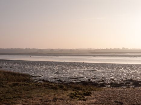 Various shots of the river and the mud, along with many birds, buoys, and other sea structures, as the sun sets