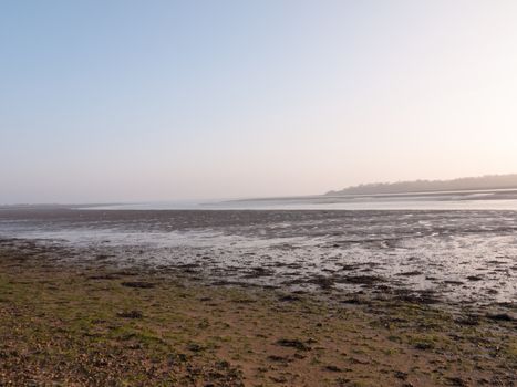 Various shots of the river and the mud, along with many birds, buoys, and other sea structures, as the sun sets