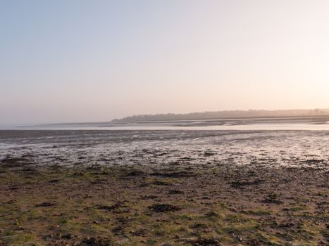 Various shots of the river and the mud, along with many birds, buoys, and other sea structures, as the sun sets