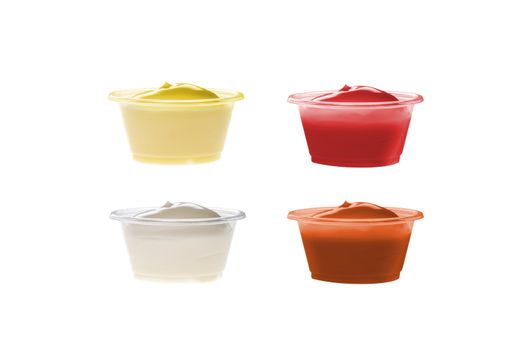 Plastic containers with sauces ketchup mustard dips on white background. Collection.