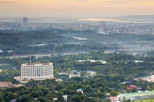 Mandalay with lake mountains, temples and pagodas seen from mandalay hill at sunset, Burma.