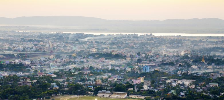 Mandalay with lake mountains, temples and pagodas seen from mandalay hill at sunset, Burma.