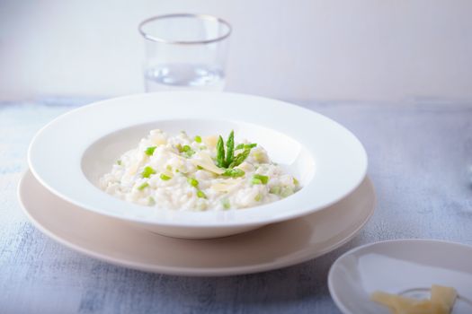 Risotto with Asparagus and cheese served on a table