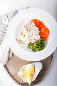 Healthy lunch with cod and steamed vegetables