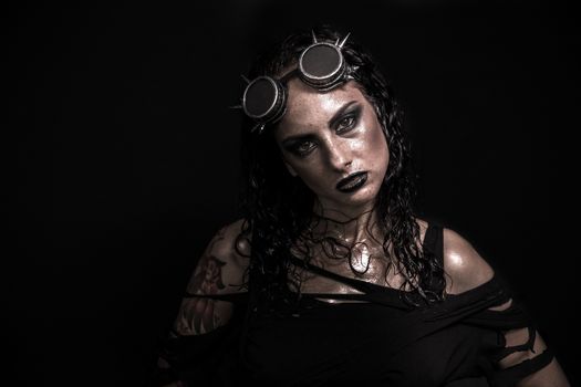 Portrait of Brutal Steampunk Girl over Black Background