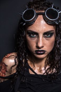 Portrait of Brutal Steampunk Girl over Black Background