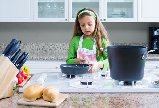 view of young beautiful girl cooking at the kitchen