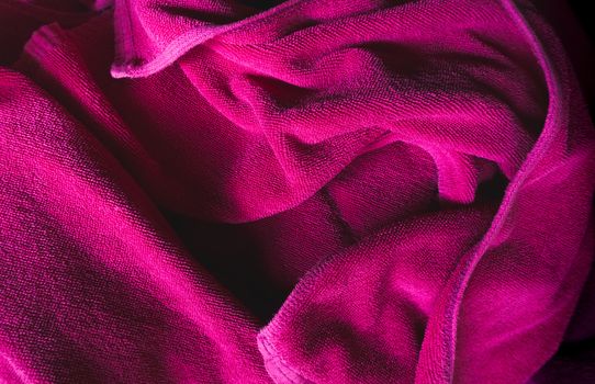 Crumpled purple fabric textile texture background.