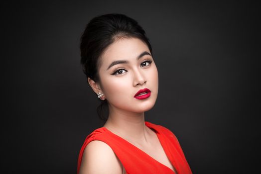 Closeup of beautiful sexy girl with bright makeup and red lips. Beauty fashion asian woman.