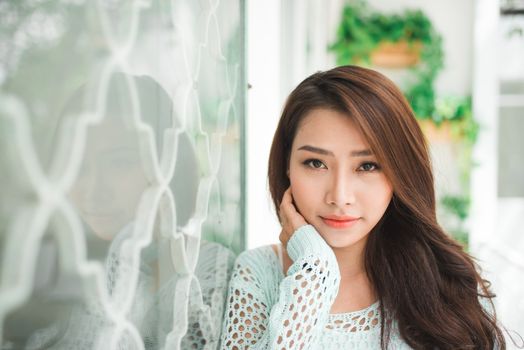 Asian woman enjoying fresh air at home
