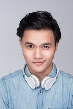 Smart casual asian man with headphone in studio background