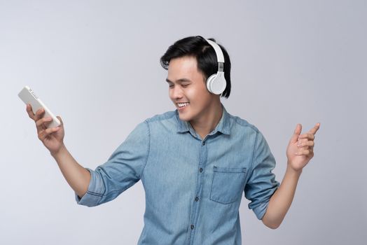 Smart casual asian man with headphone in studio background