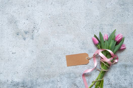 Pink tulips with decorative silk ribbon and blank gift label