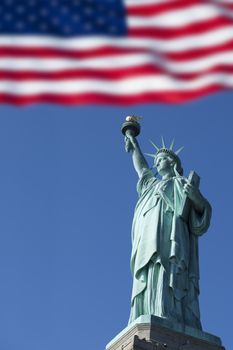 Statue of Liberty and the US Flag, New York City. New York. USA