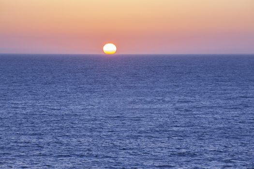 The Sun setting into the ocean