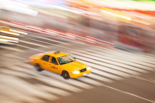 Yellow Taxi Cabin in motion, in Times Square, New York City, New York, USA.