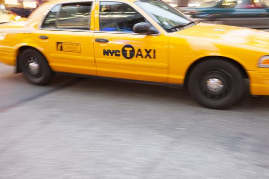 Yellow Taxi Cabin in motion, in Times Square, New York City, New York, USA.