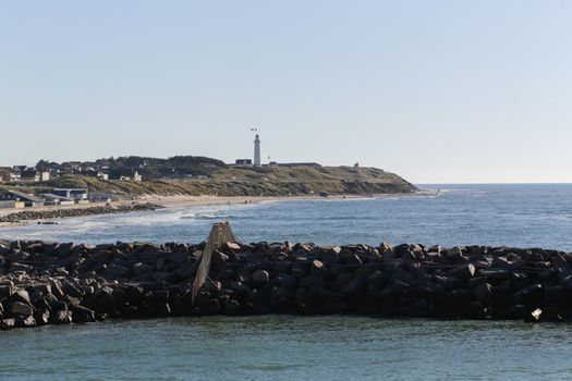 The coastline of Hirtshals and a lighthouse in the background
