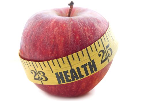Health printed on a measuring tape wrapped around an apple 