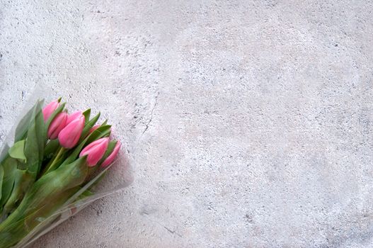 Pink tulips on shabby chique background with space for text 