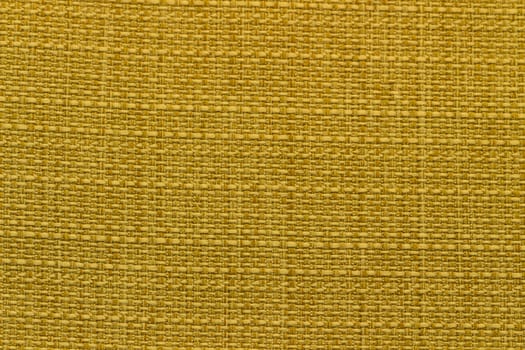 Rustic canvas fabric texture in yellow color and tweed pattern.