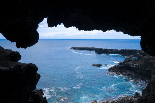 Cliffs and pacific ocean landscape vue from Ana Kakenga cave in Easter island, Chile