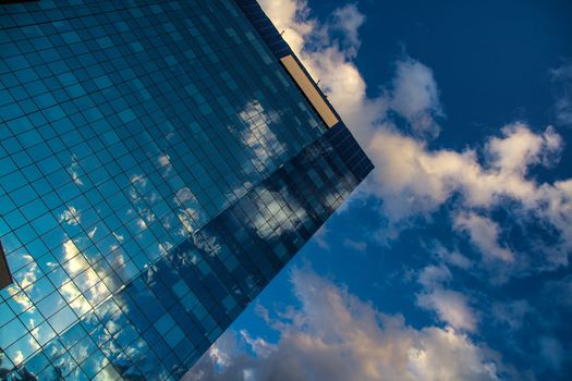 Reflected clouds in the mirror of skyscrapper