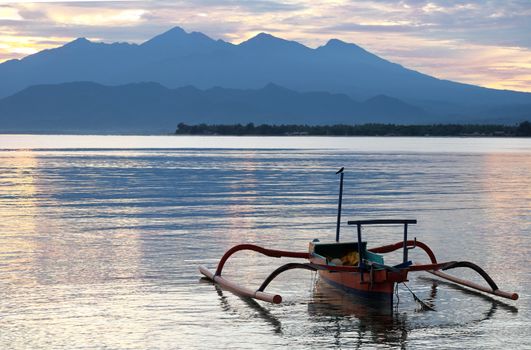The boat in the sea in the morning near Rinjani volcano, lombok, indonesia