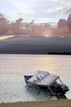 Drowned boat with dramatic morning clouds in the background