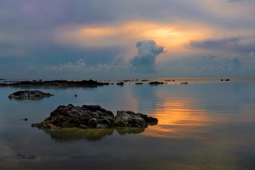 Stones in the sea at beautiful dusk sunrise