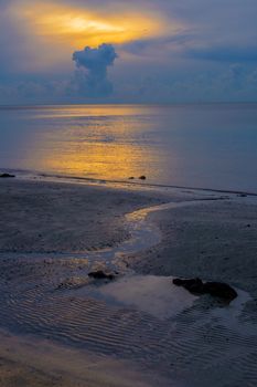 Small creek run into the sea at beautiful sunrise dusk.