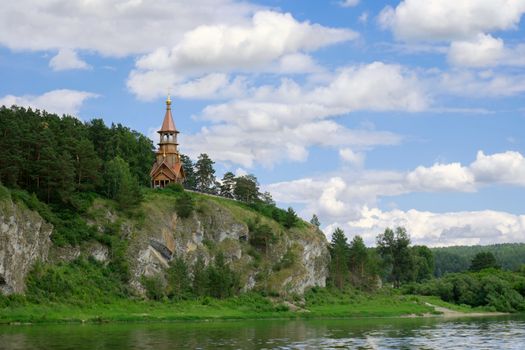 Beautifull wooden christian orthodox church on the bank of the river. Sts Kirill and Methodius chapel at Tomskaya pisanitsa. Siberia. Taiga.