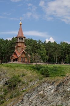 Beautifull wooden christian orthodox church on the bank of the river. Sts Kirill and Methodius chapel at Tomskaya pisanitsa. Siberia. Taiga.