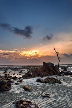 Colourful sunrise and sand  when sea water left during low tide