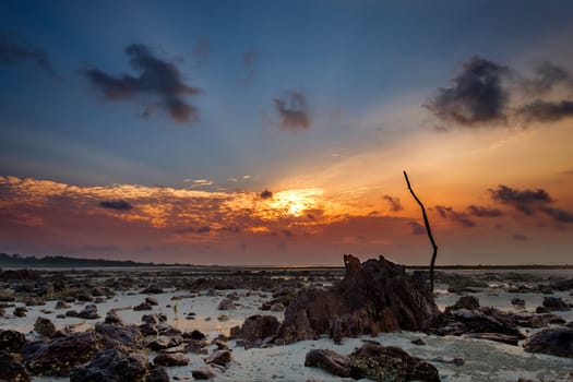 Colourful sunrise and sand  when sea water left during low tide