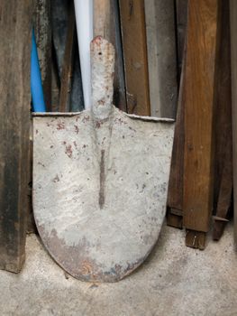 COLOR PHOTO OF OLD RUSTIC SHOVEL ON THE GROUND