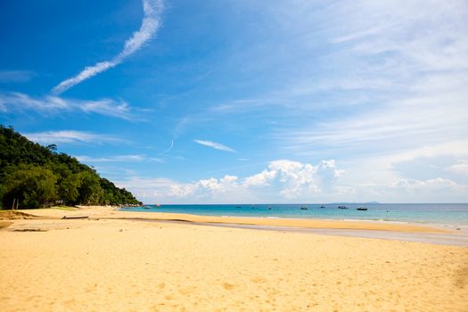 Sunny day at the beach on Tioman Island. Blue sky some clouds, sea and sandy beach