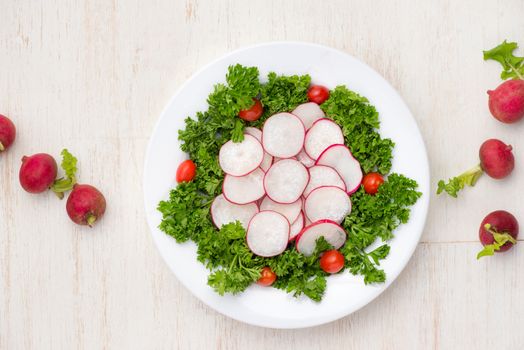 Homemade fresh radishes vegetable salad on table. Close-up.