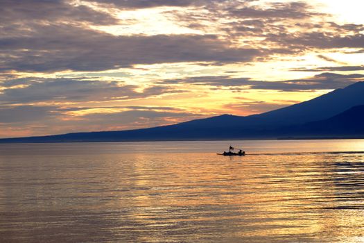 Fisherman boat with lombok volcano Rinjani in the background before the sunrise