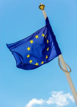 flag of the European Union with clouds underneath symbolizing darkening