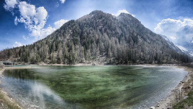 Lake of the Fairies with mountain and blue sky in background near little village of Macugnaga