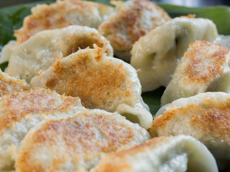 COLOR PHOTO OF FRIED DUMPLINGS FILLED WITH MINCED CHICKEN AND SPRING ONION