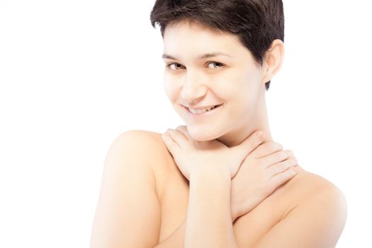 girl with a short hair touching her neck, smiling and looking at camera