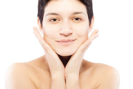 girl with a short hair touching her face, smiling and looking at camera